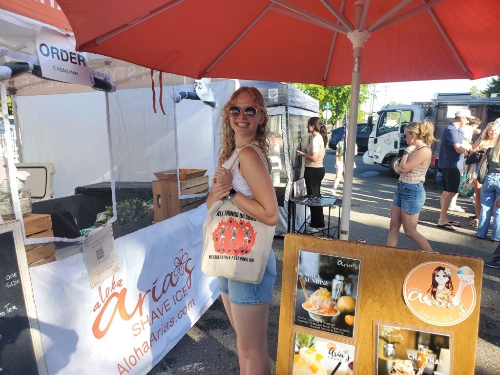 Georgetown student standing at a farmer's market