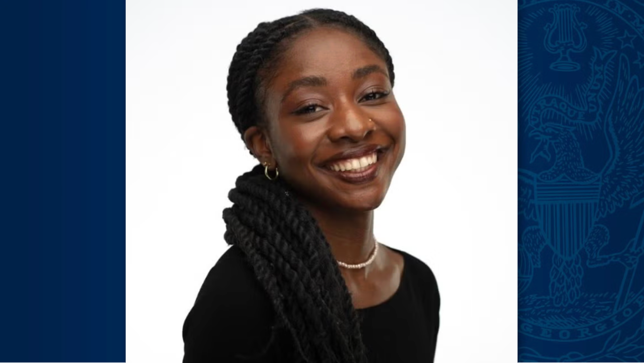 Georgetown alumna, Fatima Yunusa, stands in front of a white background layed over a blue box with the Georgetown seal in the background.