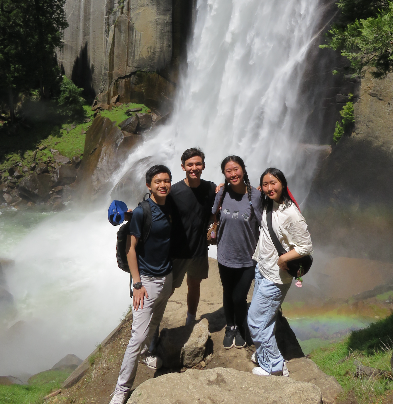Student researchers pose in front waterfall at Yosemite National Park
