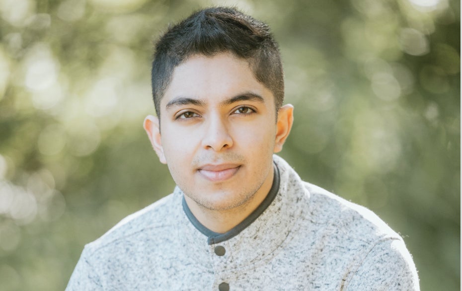 Ishaan Sharma in a portrait photo with a blurry outdoor background
